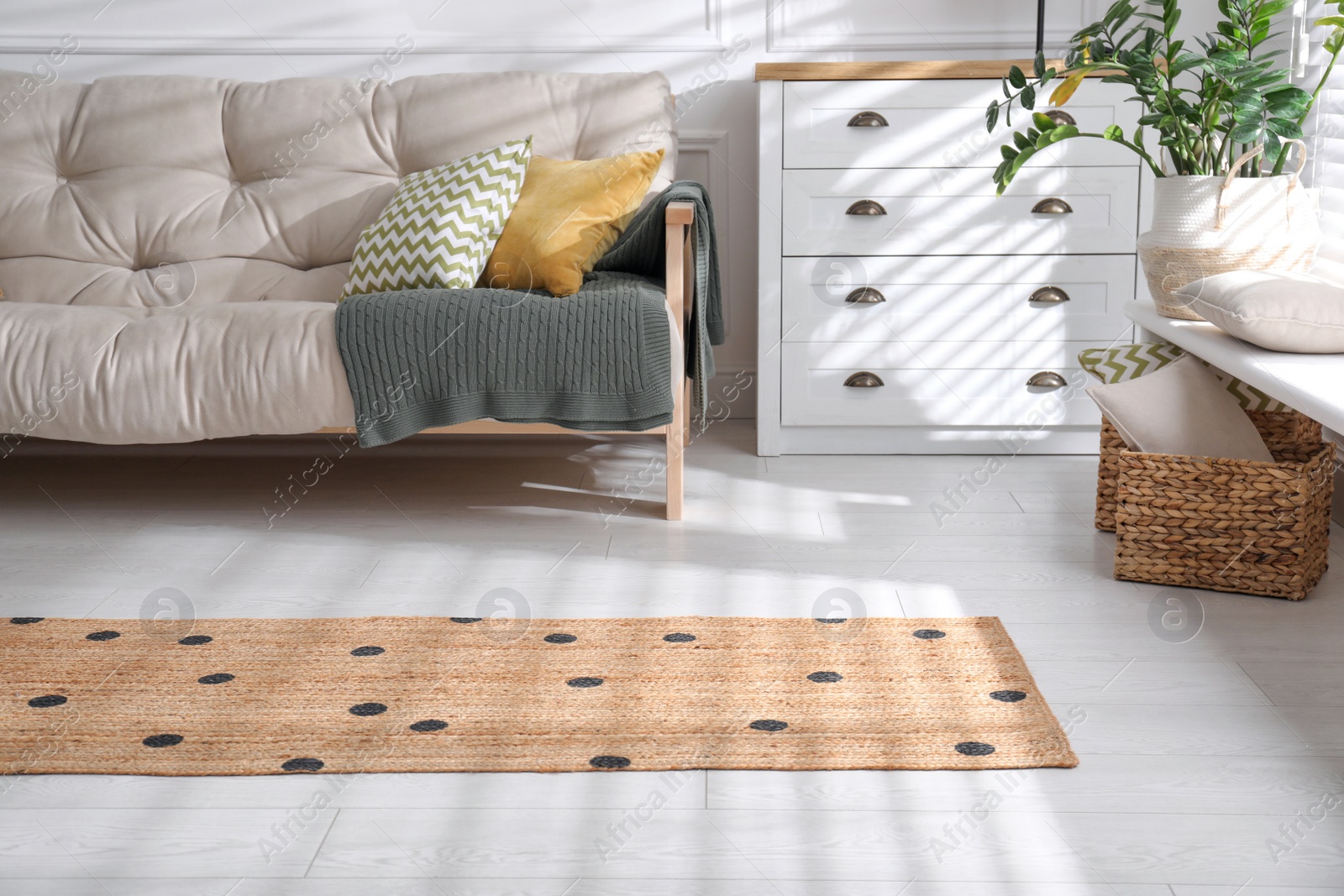 Photo of Stylish rug with dots on floor in living room