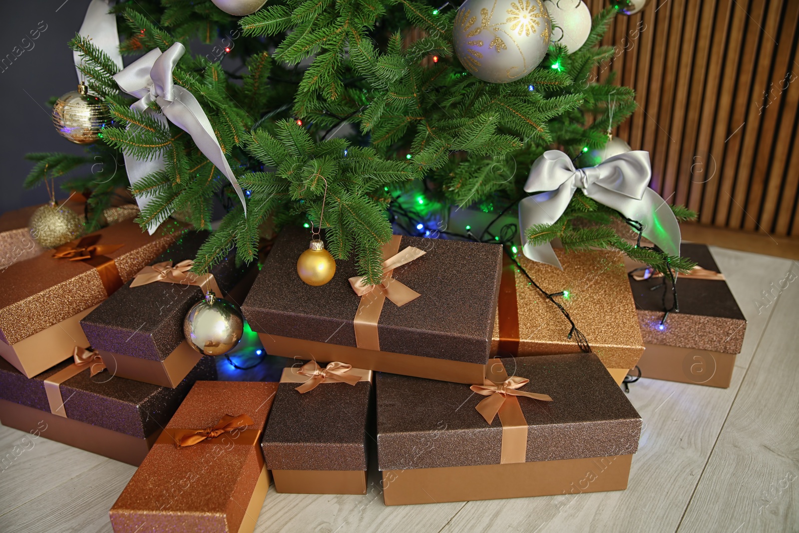 Photo of Beautiful Christmas tree and gift boxes indoors