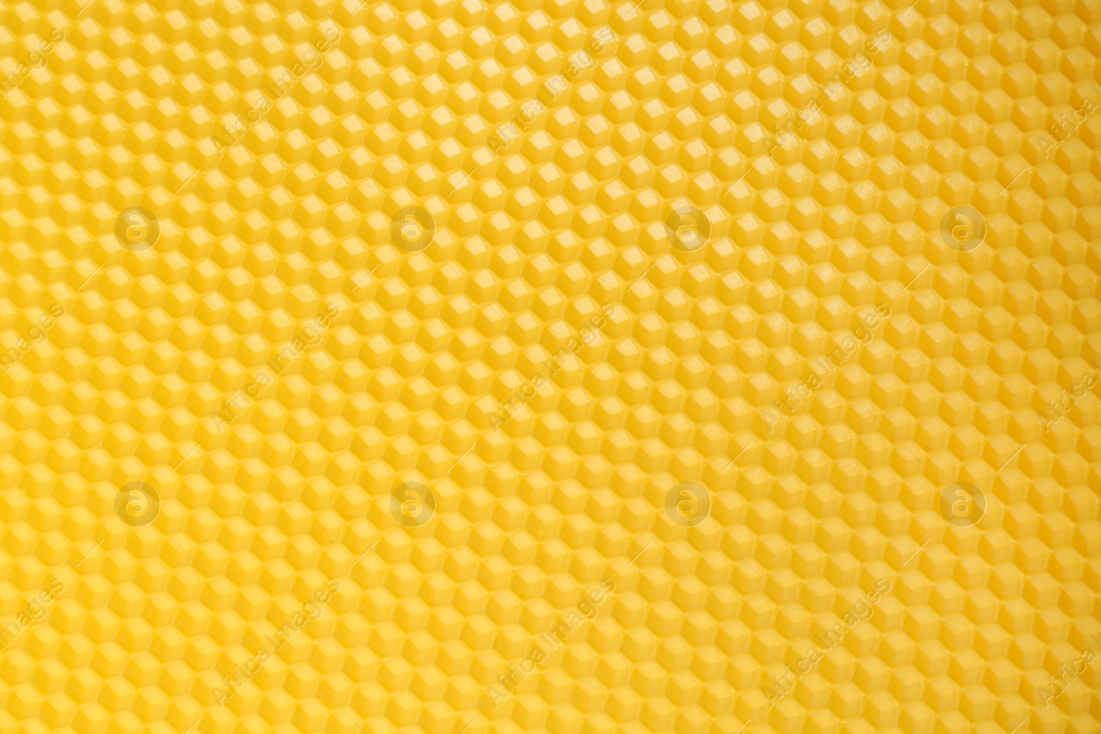 Photo of Natural beeswax sheet as background, top view