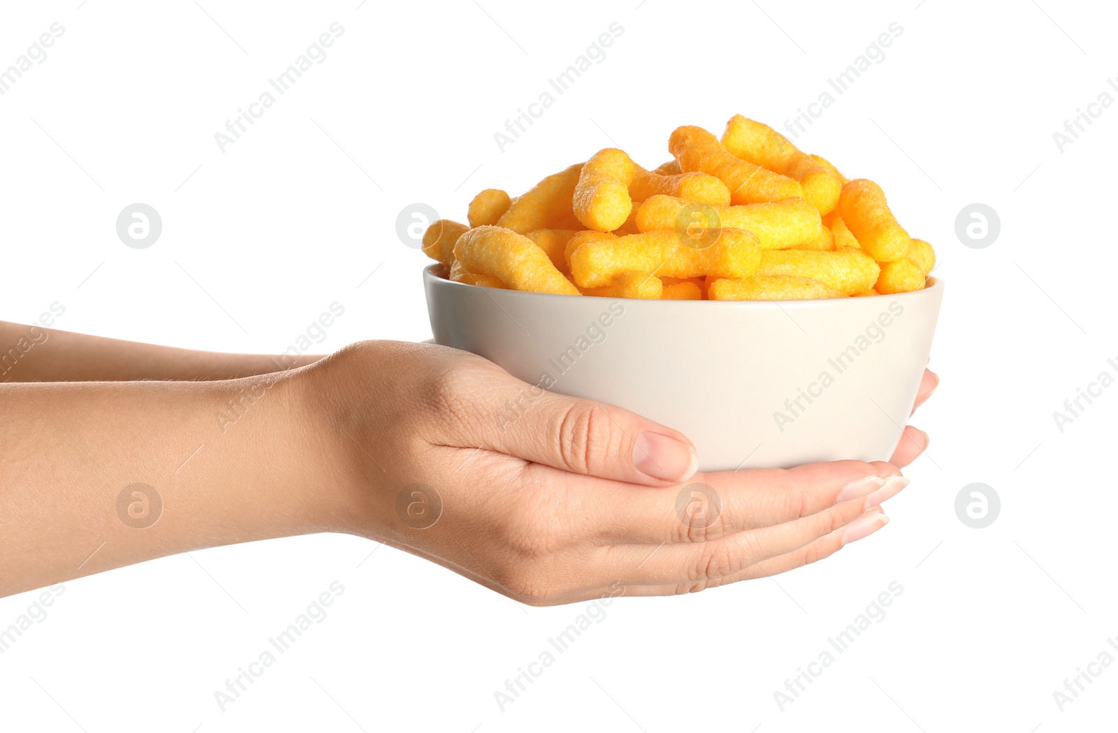 Photo of Woman holding bowl of crunchy cheesy corn sticks on white background, closeup