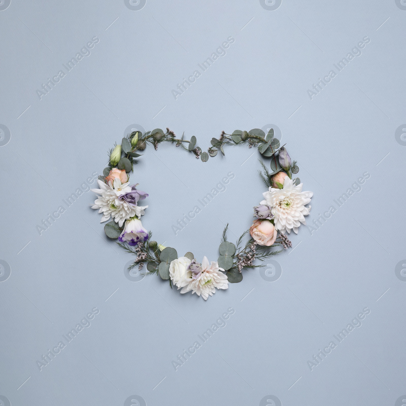Photo of Beautiful heart made of different flowers on light gray background, flat lay. Space for text