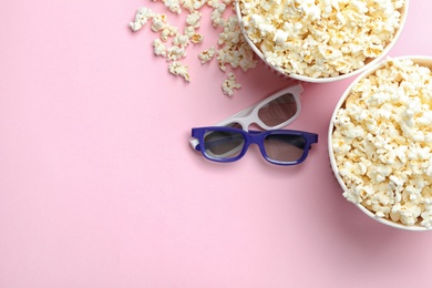 Popcorn and 3D glasses on pink background, flat lay with space for text. Cinema snack