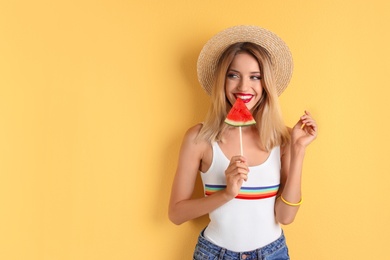 Photo of Pretty young woman with juicy watermelon on color background