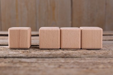 Photo of Cubes with check mark and abbreviation ISO on wooden table