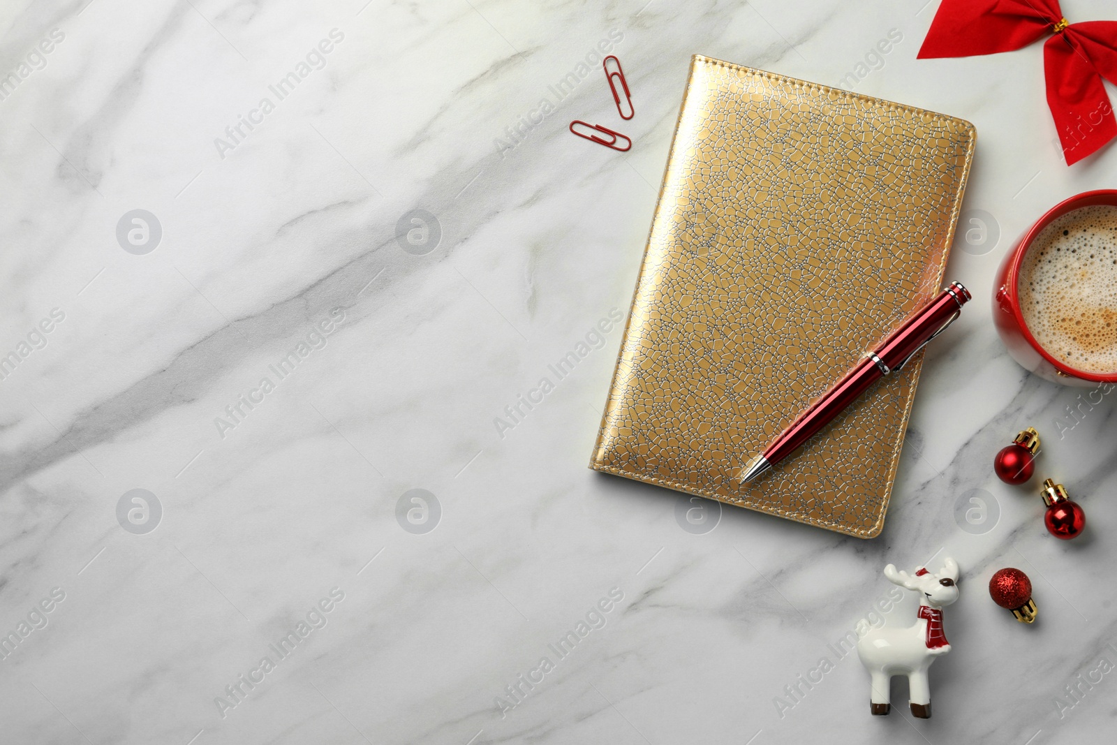 Photo of Stylish planner, cup of coffee and Christmas decor on white marble background, flat lay with space for text. New Year aims