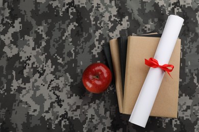 Photo of Books, apple and diploma on camouflage background, flat lay with space for text. Military education concept