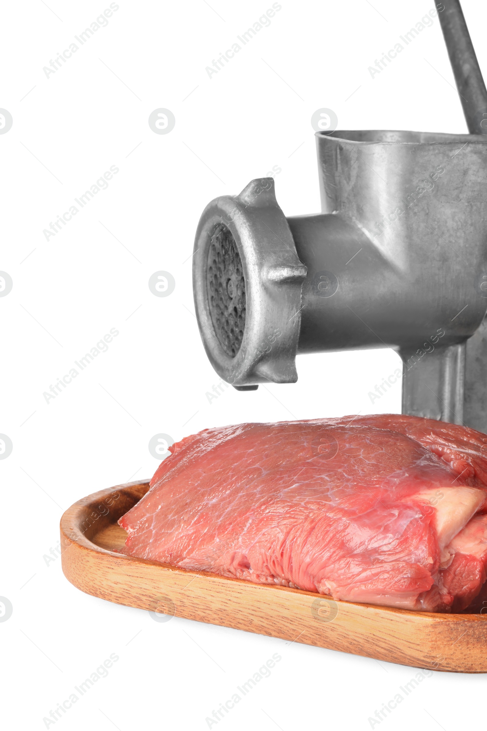 Photo of Metal meat grinder, beef and board isolated on white