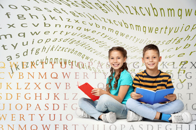 Little children reading books on grey background