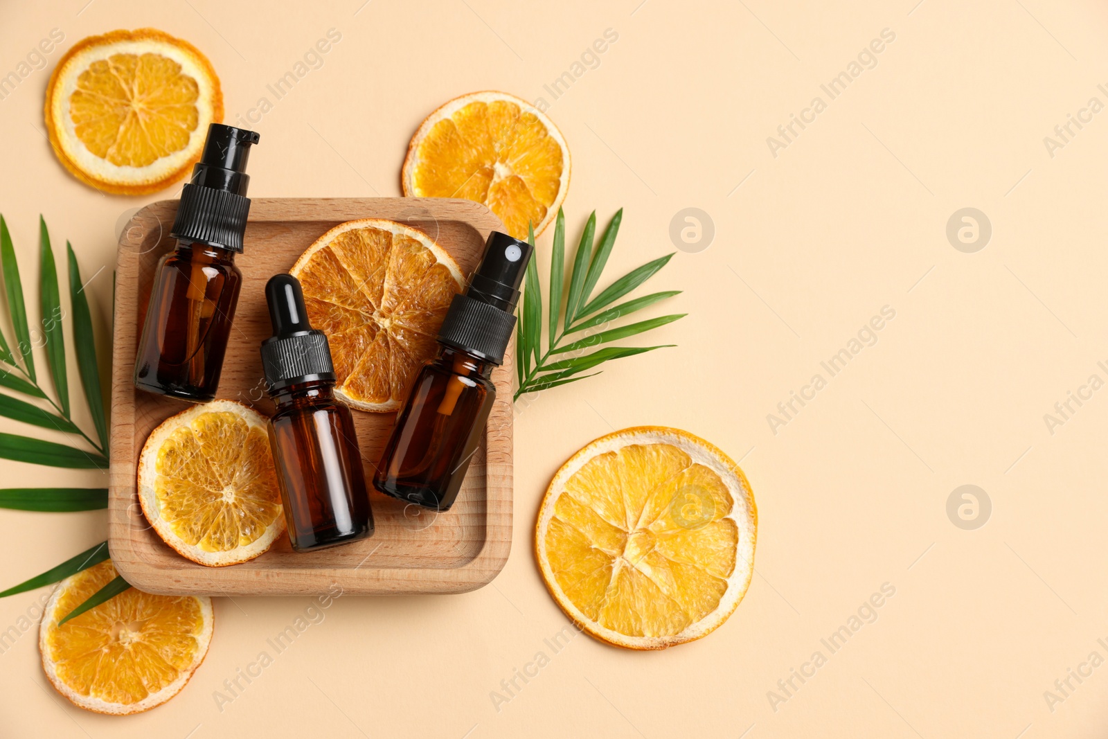 Photo of Flat lay composition with bottles of organic cosmetic products on beige background, space for text