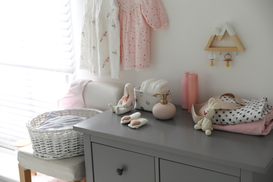 Stylish chest of drawers and accessories in child room