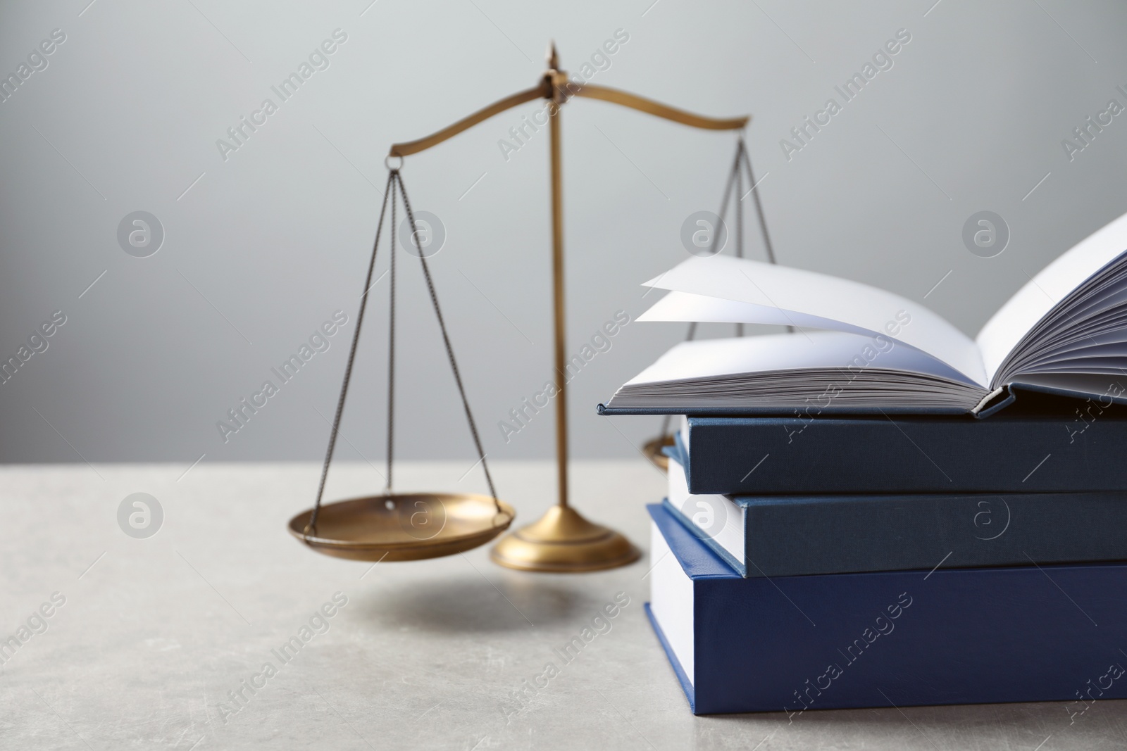 Photo of Scales of justice and books on table. Law concept