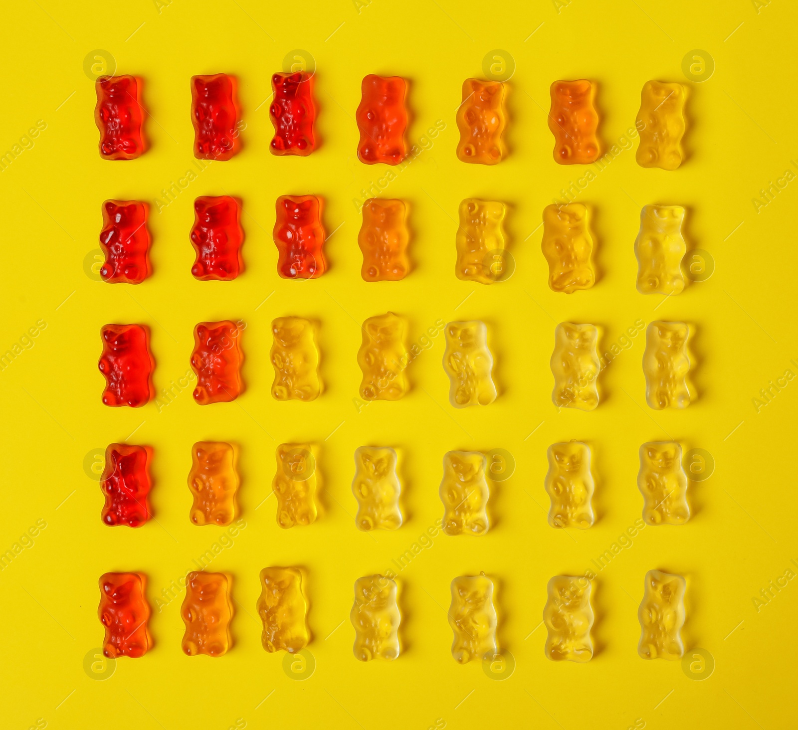 Photo of Flat lay composition with delicious jelly bears on color background