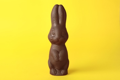 Photo of Chocolate bunny on yellow background. Easter celebration