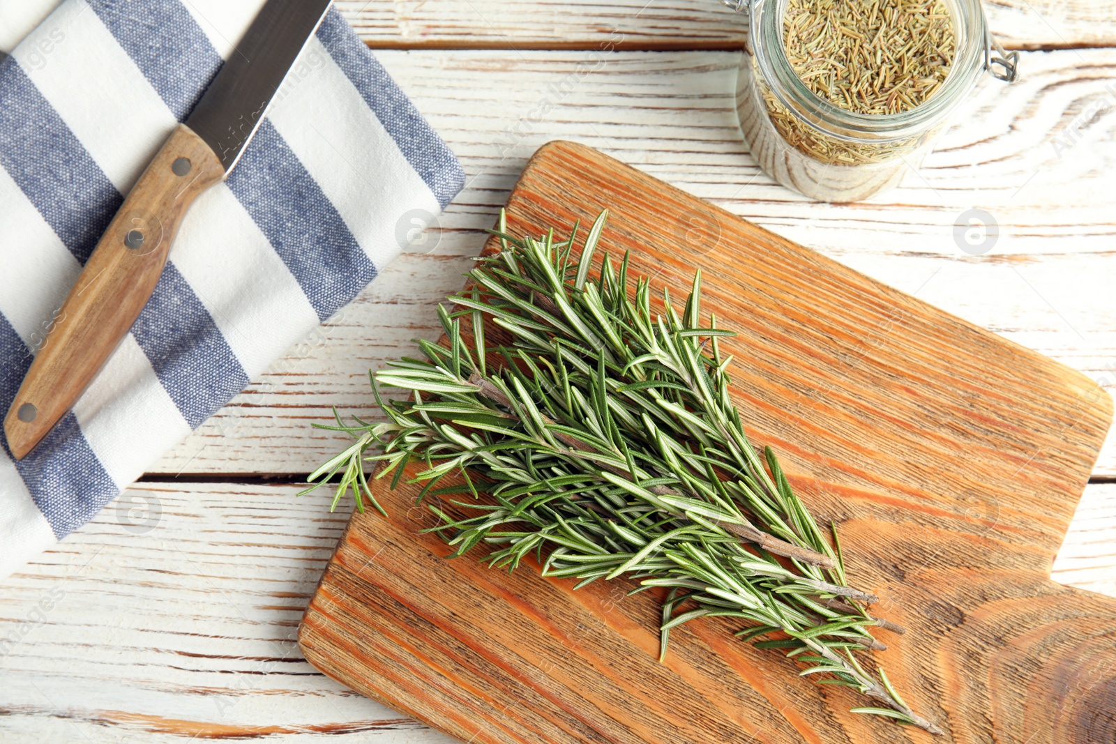 Photo of Flat lay composition with fresh rosemary twigs on wooden table