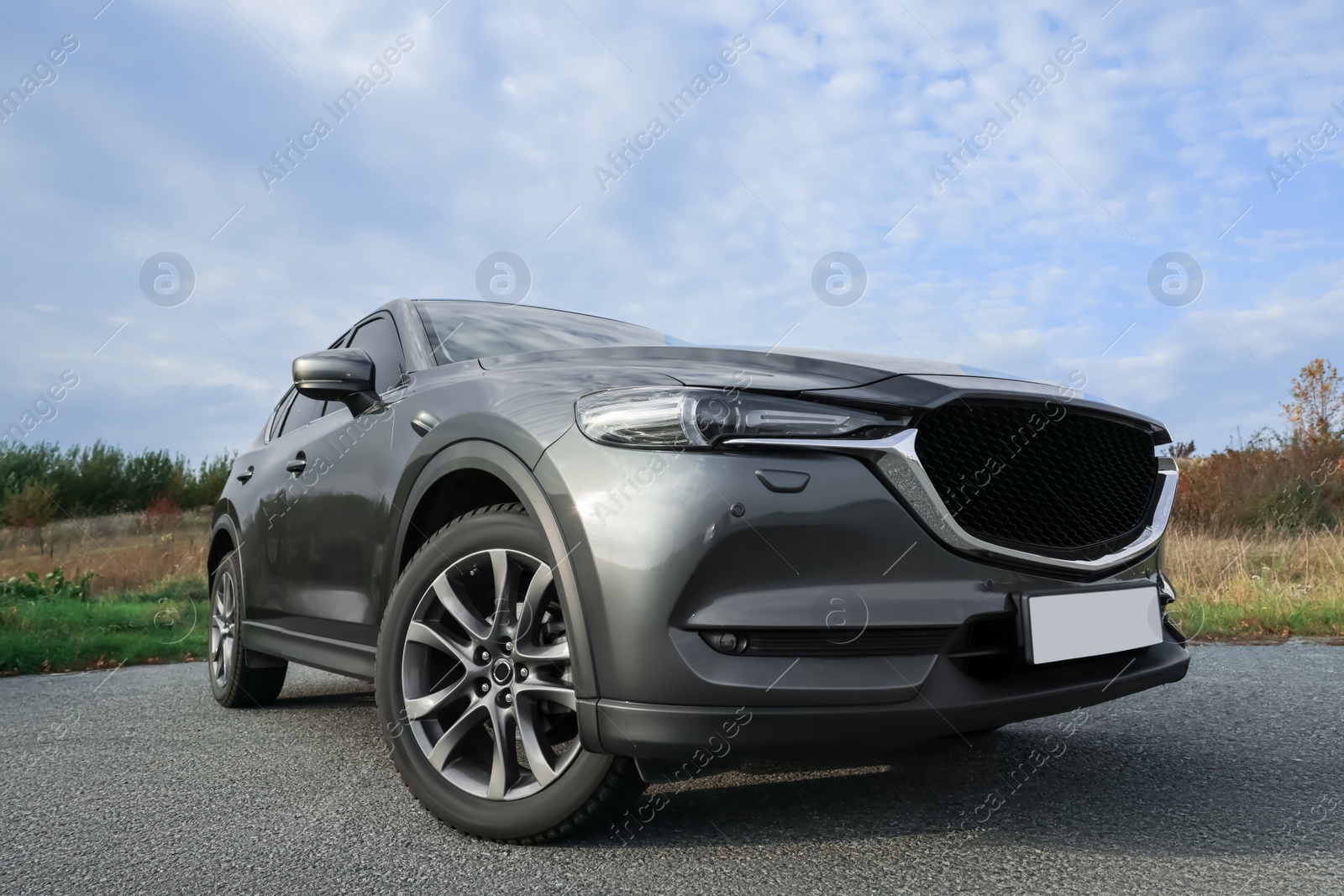 Photo of Black modern car parked on asphalt road