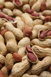 Many fresh unpeeled peanuts as background, closeup