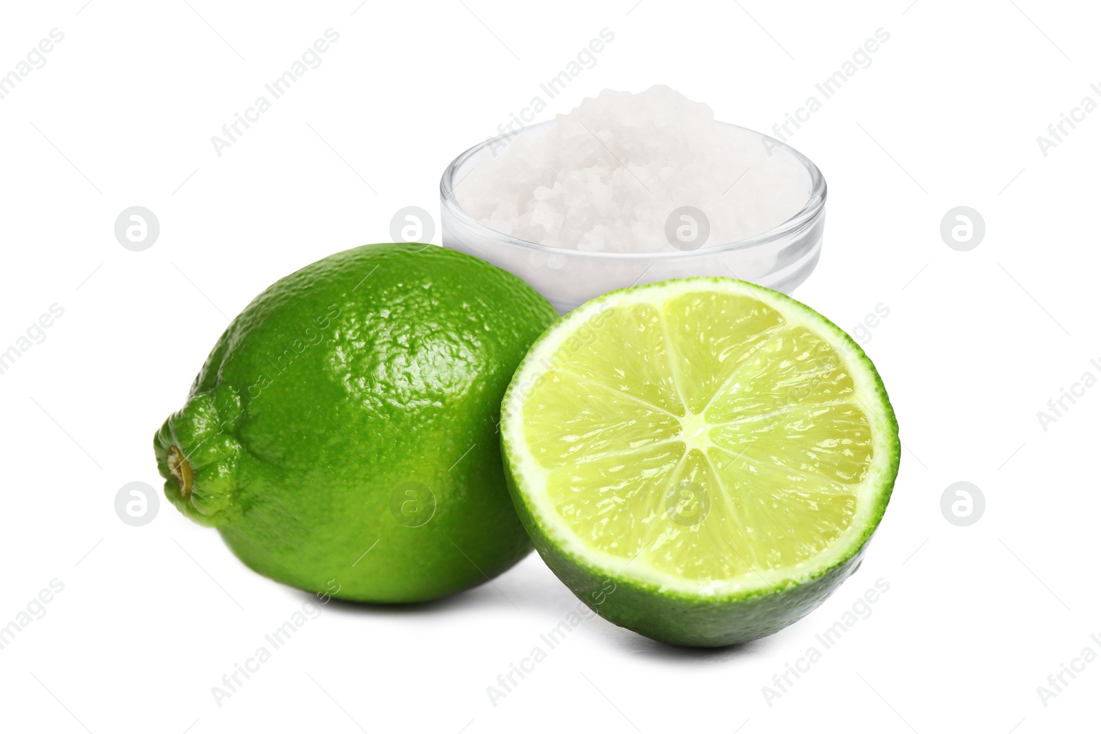 Image of Limes and salt isolated on white. Margarita cocktail ingredients