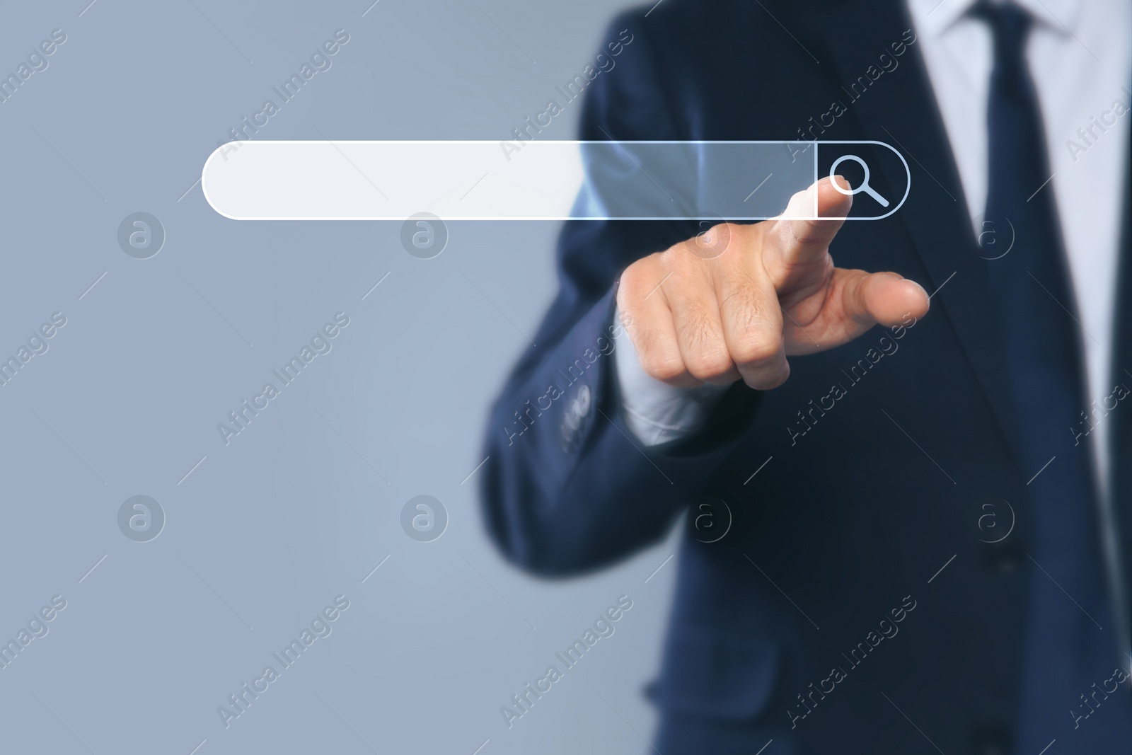Image of Man pointing at search bar on virtual screen against grey background, closeup
