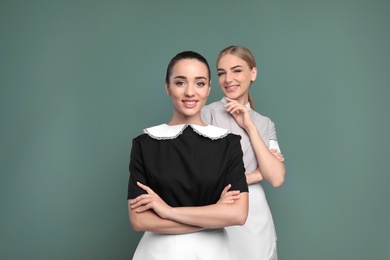 Photo of Portrait of young chambermaids on color background