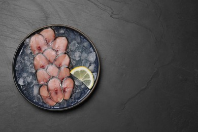Raw mackerel slices, ice cubes and lemon on grey table, top view with space for text. Fish delicacy
