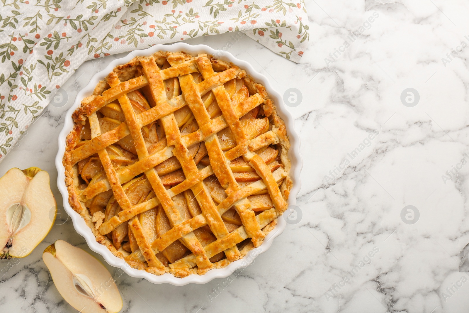 Photo of Tasty homemade quince pie and fresh fruits on white marble table, top view. Space for text