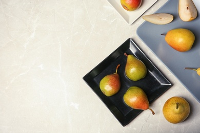 Flat lay composition with ripe pears on grey background. Space for text