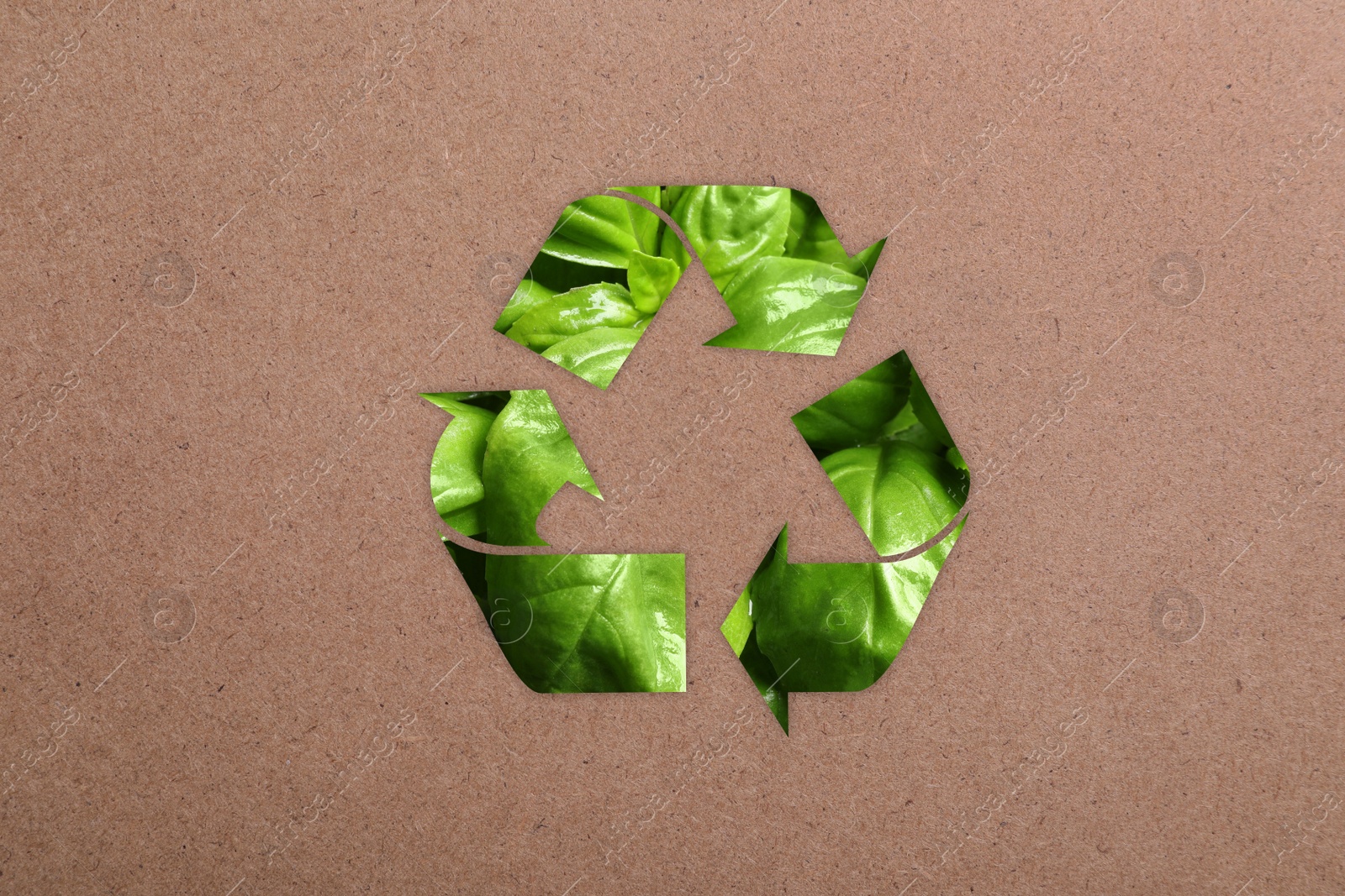 Image of Recycling symbol made of green leaves on kraft paper
