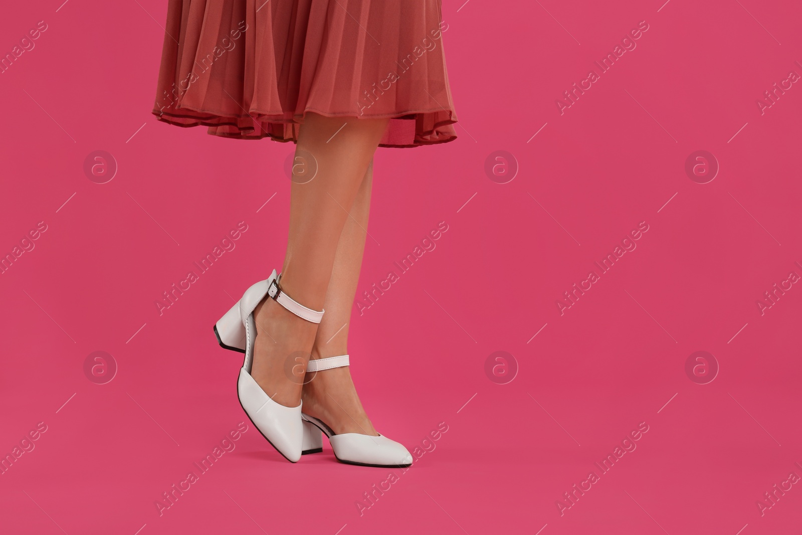 Photo of Woman wearing stylish shoes on pink background, closeup