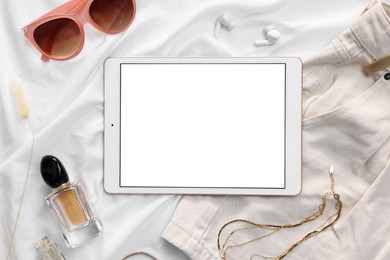Photo of Flat lay composition with modern tablet on white fabric. Space for text