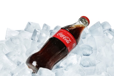 Photo of MYKOLAIV, UKRAINE - NOVEMBER 15, 2018: Bottle of Coca Cola on ice cubes against white background