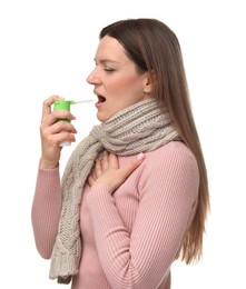 Woman using throat spray on white background