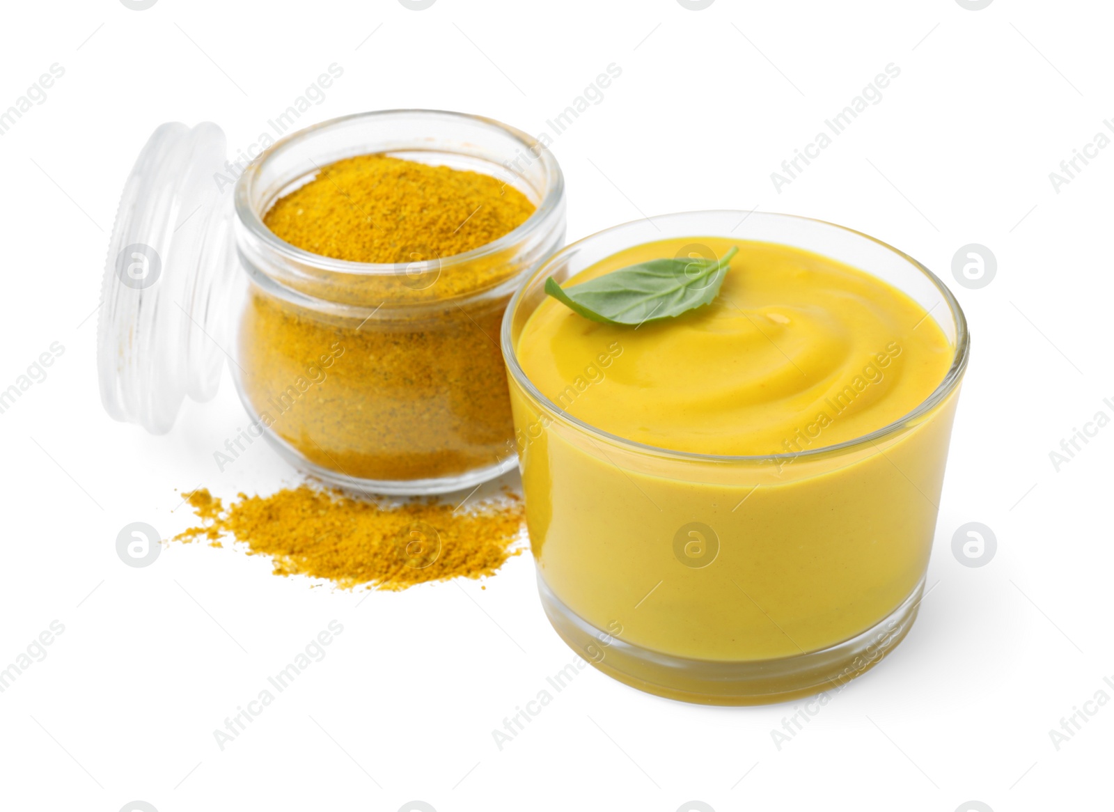 Photo of Tasty curry sauce, powder and basil leaf isolated on white