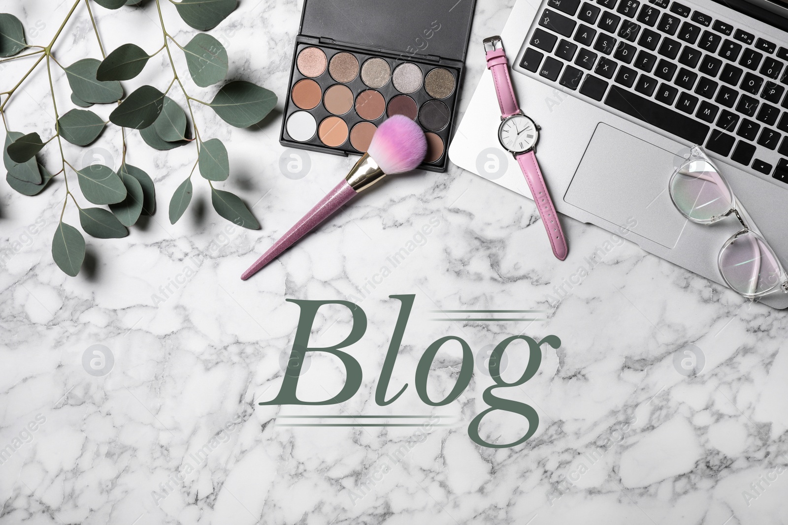 Image of Blogger's workplace with laptop and makeup products on white marble background, flat lay