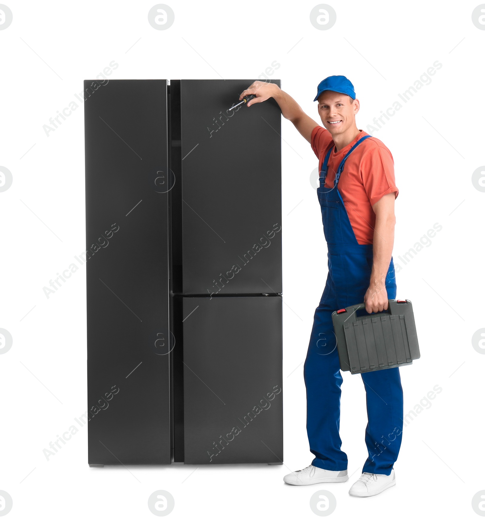 Photo of Male technician with tool box near refrigerator on white background