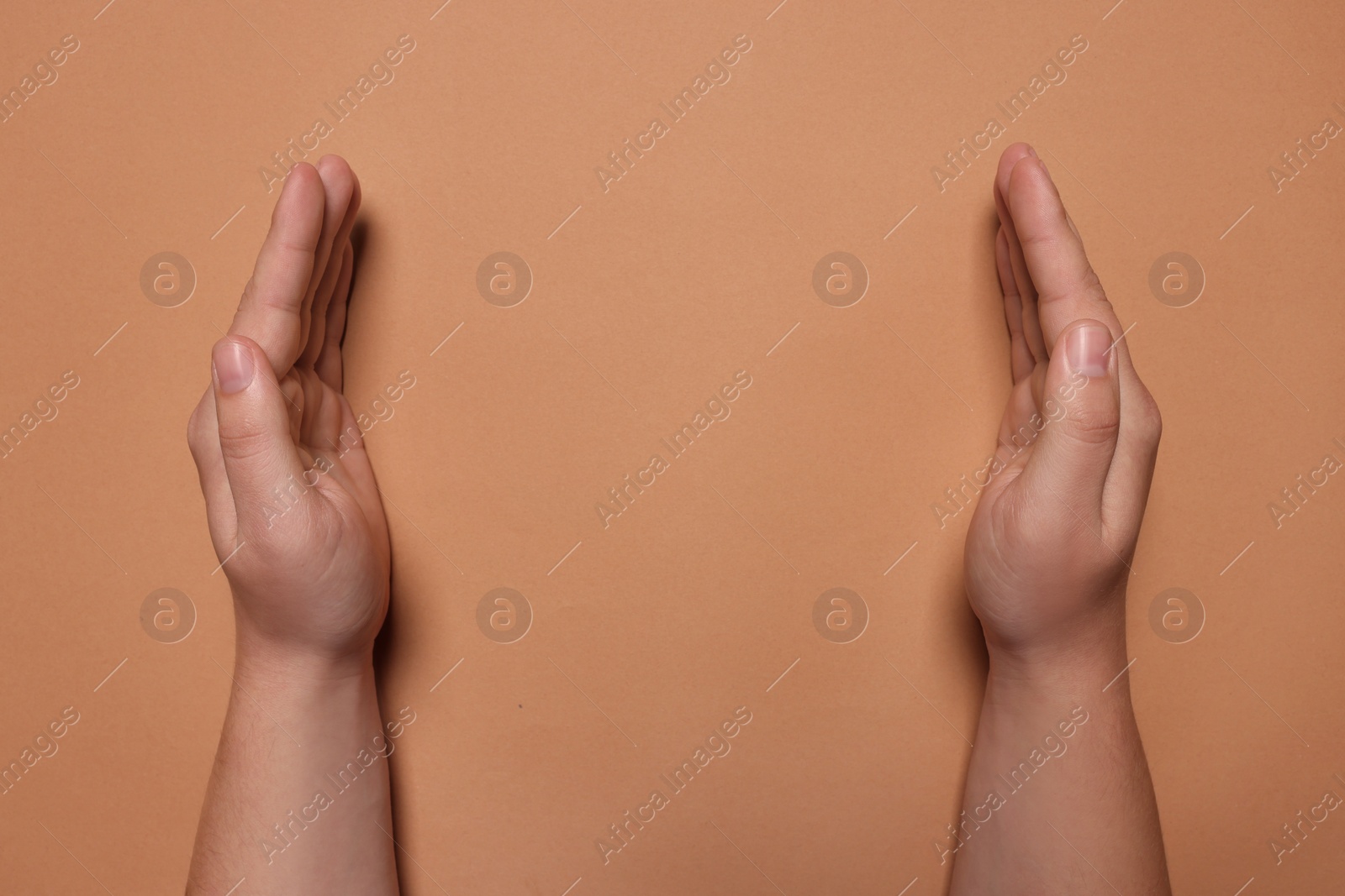 Photo of Woman holding on coral background, closeup of hands. Space for text