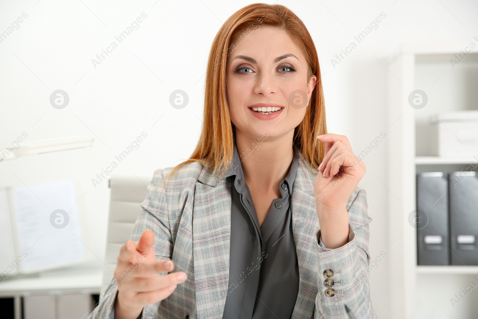 Photo of Happy woman using video chat in modern office, view from web camera