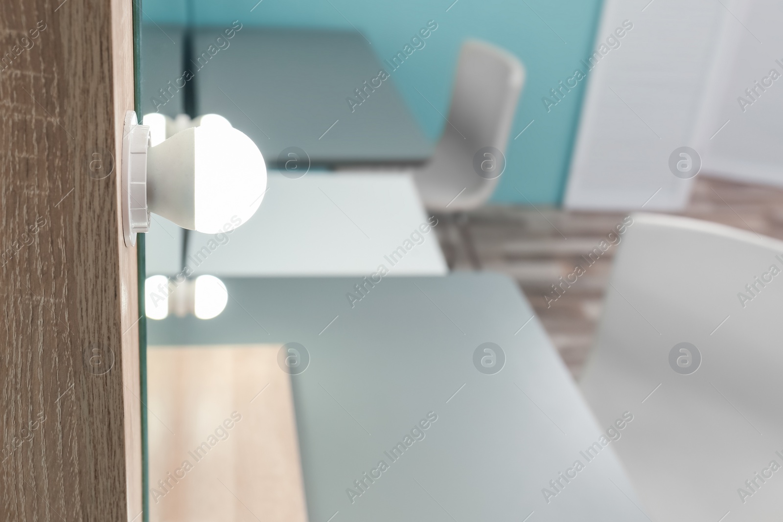 Photo of Makeup mirror with light bulbs on table in dressing room