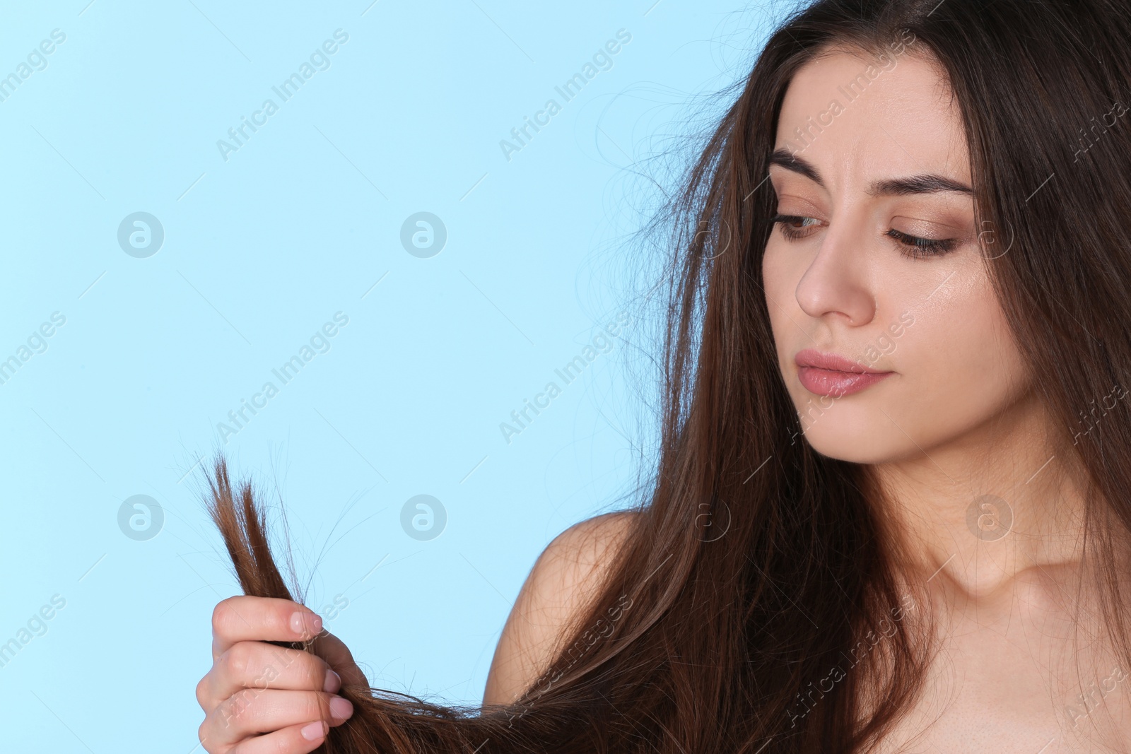 Photo of Woman with damaged hair and space for text on color background. Split ends