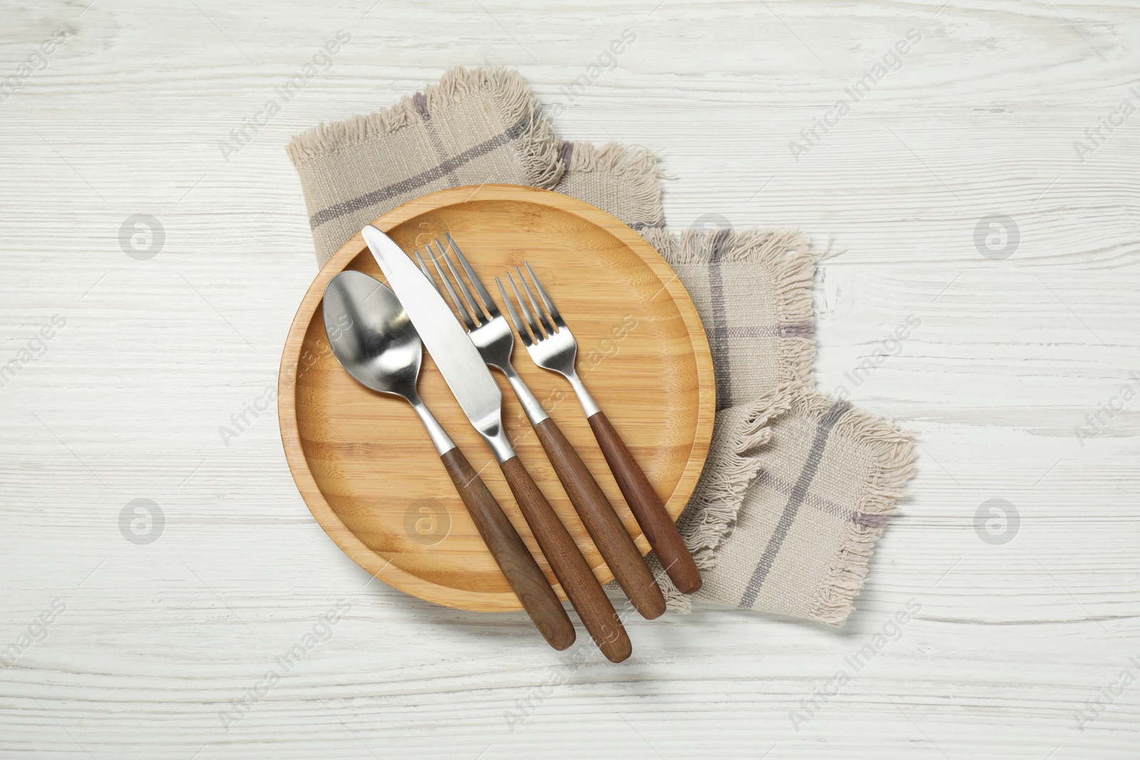 Photo of Stylish setting with elegant cutlery on white wooden table, top view