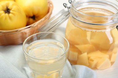 Delicious quince drink and fresh fruits on table, closeup