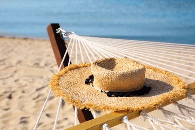 Photo of Hammock and hat at seaside. Time to relax