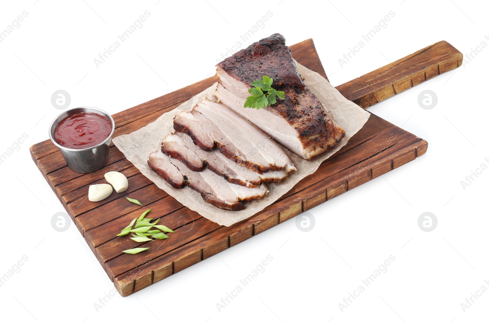 Photo of Pieces of tasty baked pork belly and sauce isolated on white