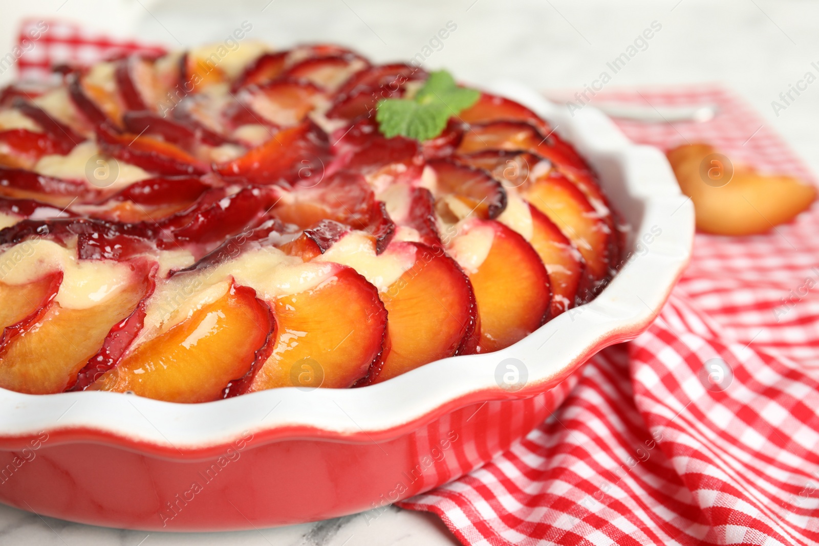 Photo of Delicious cake with plums on table, closeup