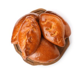 Wooden board with delicious baked patties on white background, top view