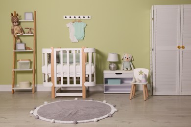 Photo of Baby room interior with stylish wooden furniture