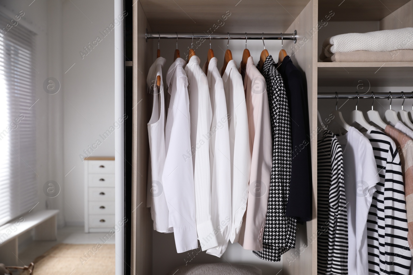 Photo of Wardrobe closet with different stylish clothes in room, closeup