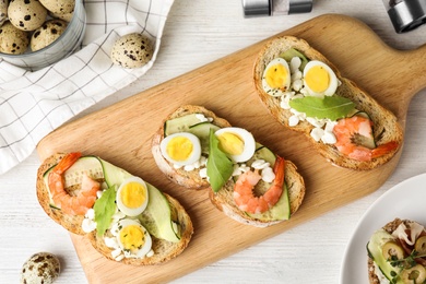 Photo of Flat lay composition with delicious bruschettas on white wooden table