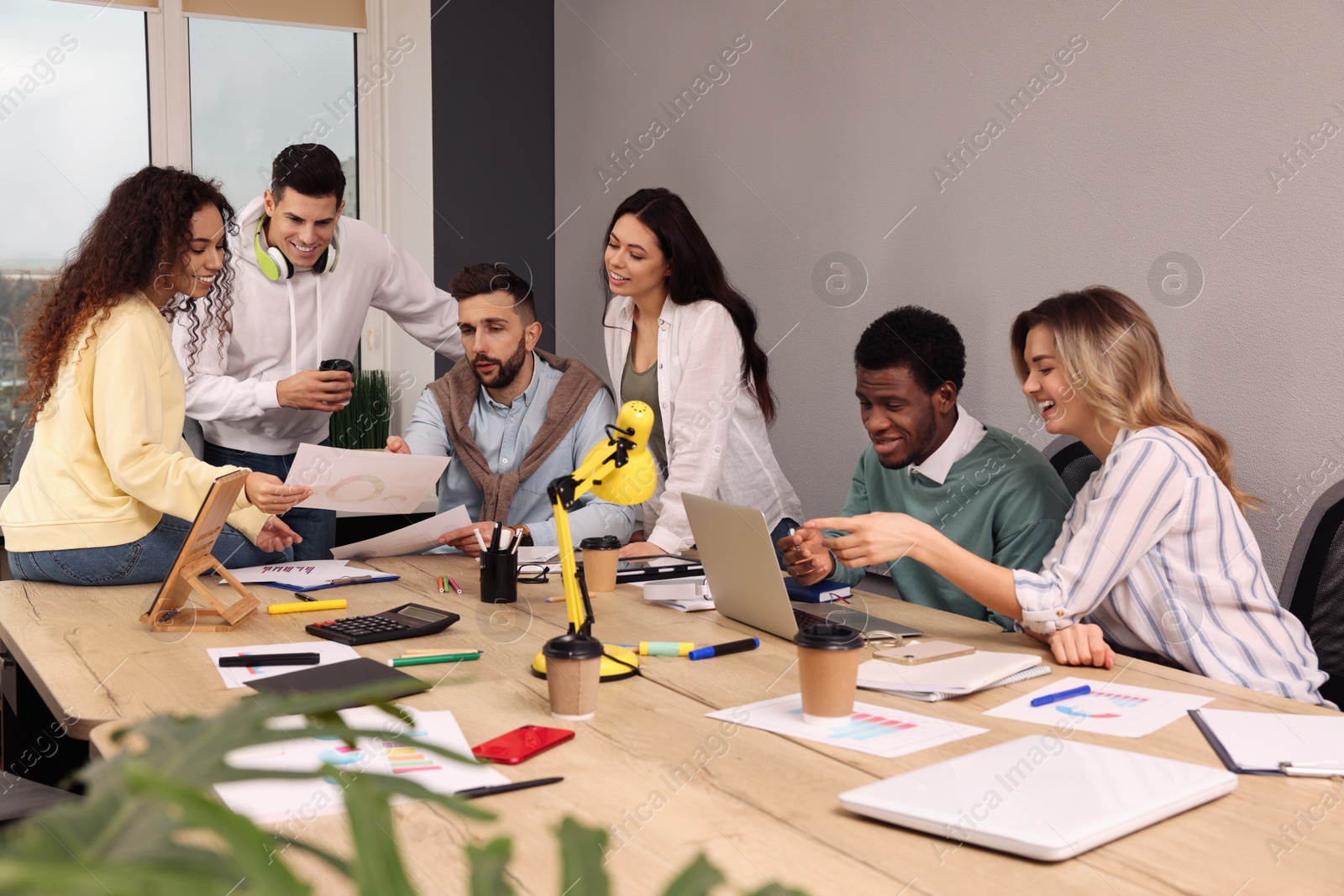 Photo of Team of employees working together in office. Startup project