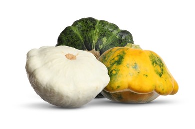 Three fresh different pattypan squashes on white background