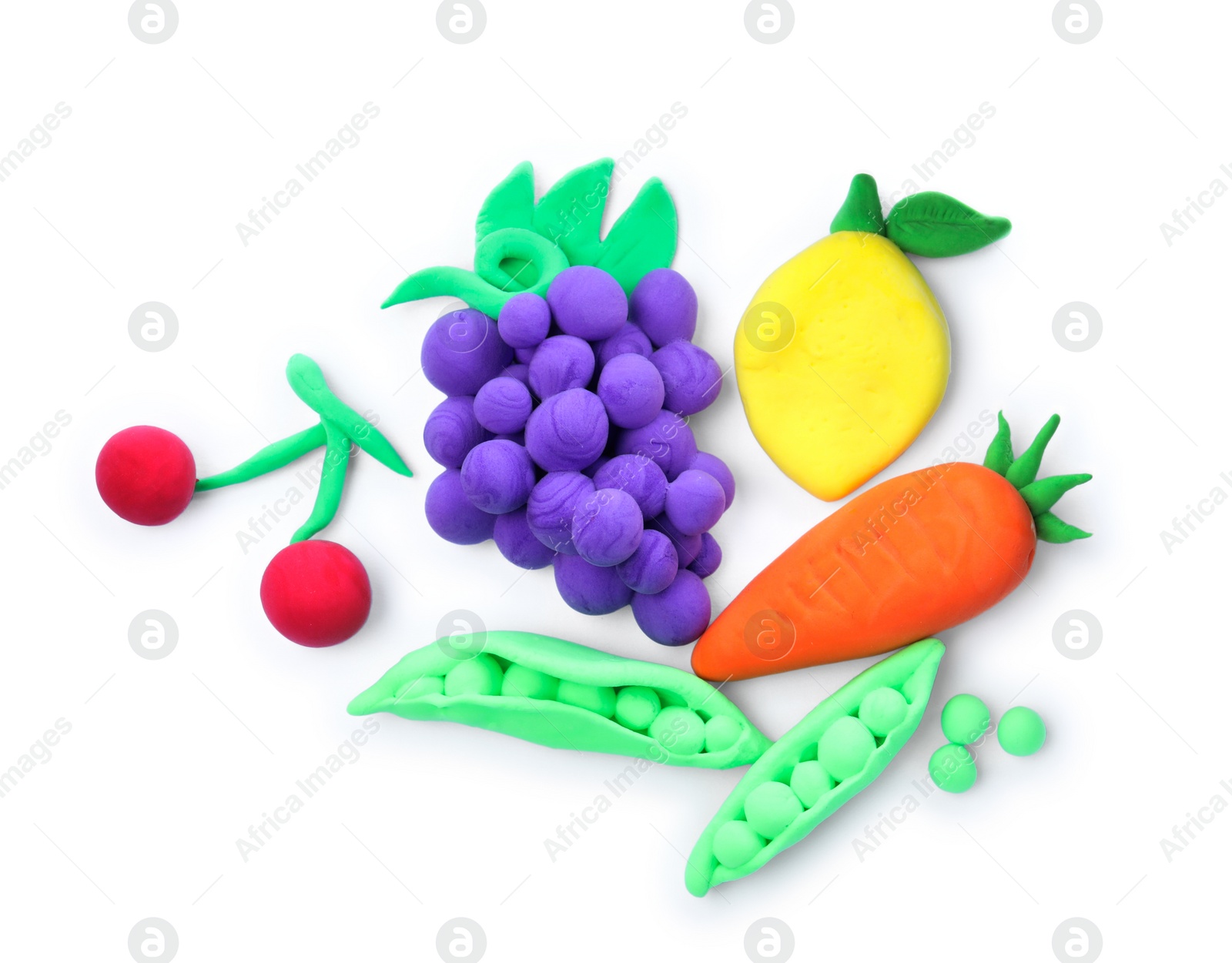 Photo of Different fruits and vegetables made from play dough on white background, top view